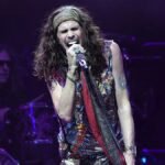 "Aerosmith's North American farewell tour faces setbacks as Steven Tyler's vocal cord damage forces show postponements. The singer expresses heartbreak due to doctor's orders."