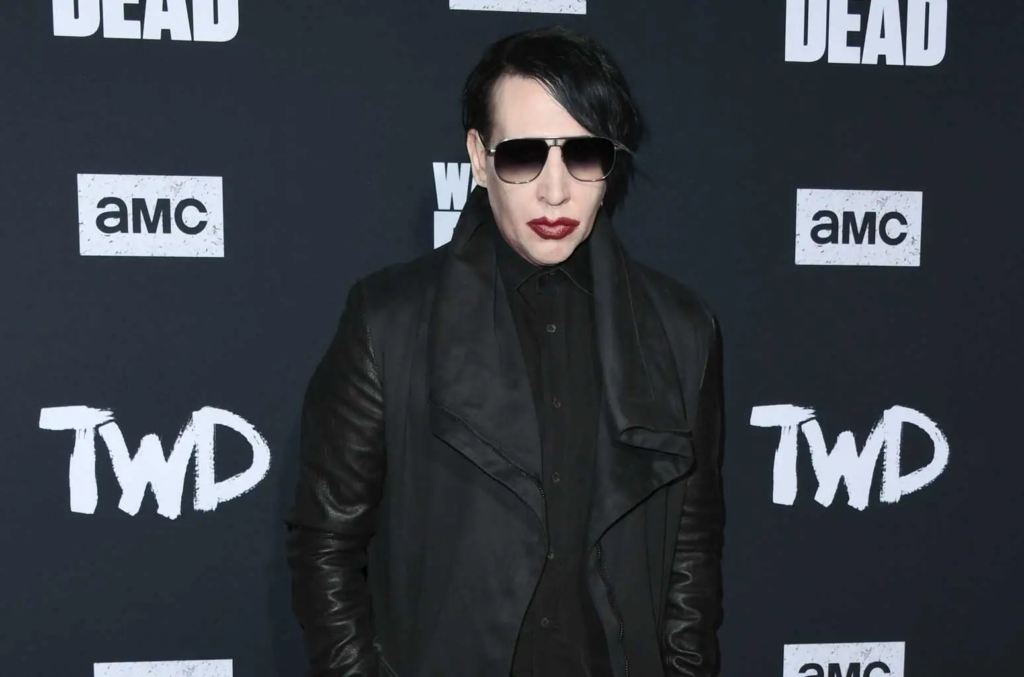 "Controversial musician Marilyn Manson fined and sentenced to community service for spitting and blowing nose on a concert camerawoman in New Hampshire."

