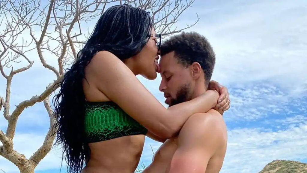 "Golden State Warriors' Ayesha Curry stuns in a black bikini during her Jamaican vacation, sparking both admiration and controversy on social media."
