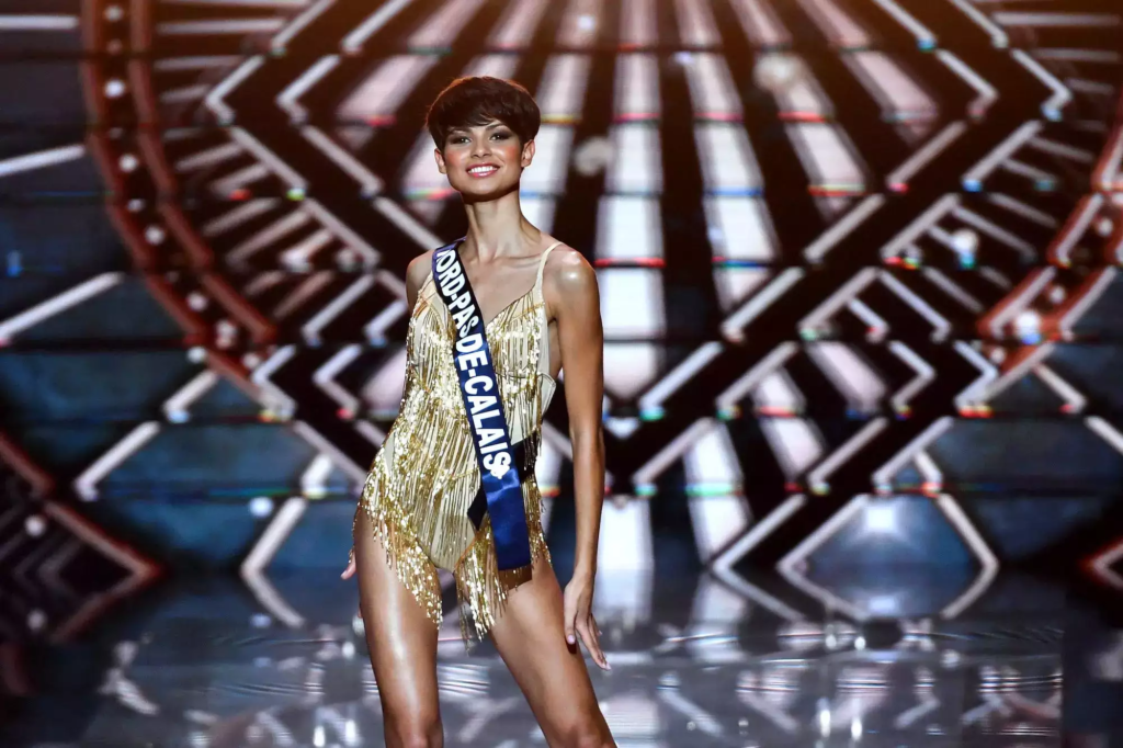 "Explore how Eve Gilles, crowned Miss France 2024, challenges beauty norms with short hair, emphasizing diversity and individuality in a historic victory."
