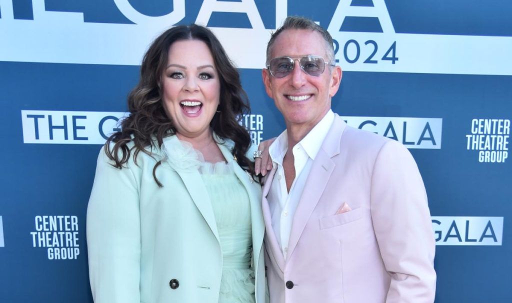 Melissa McCarthy and Adam Shankman steal the spotlight at a theater benefit gala, showcasing stunning pastel ensembles that mesmerize onlookers.